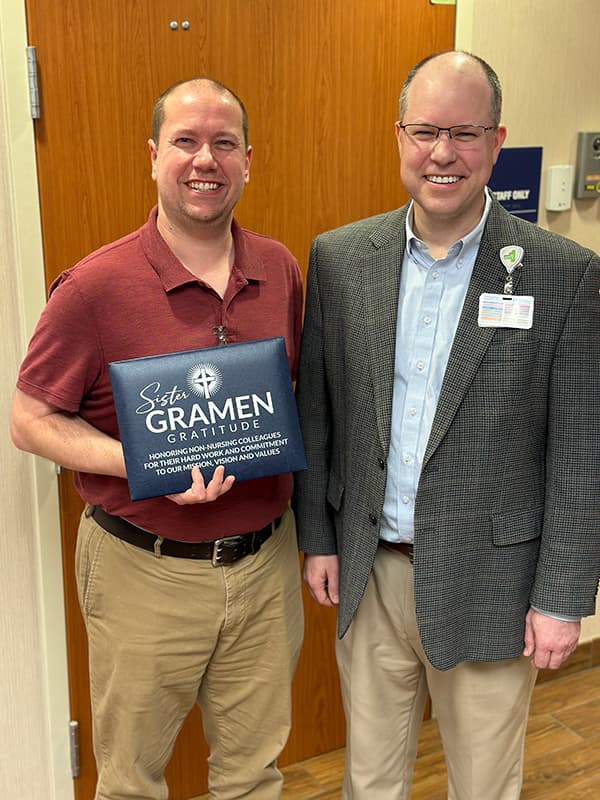 Timothy Assink with Saint Francis President and CEO Justin Davison